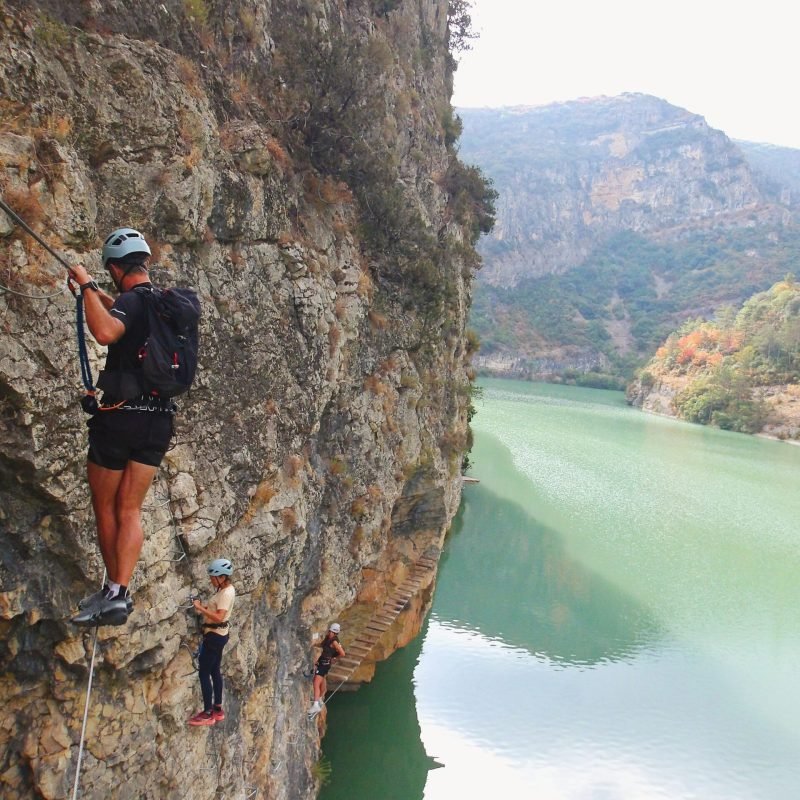 chico cruzando el puente y más personas en la vía ferrata paret de les arcades en la pobla de segur, el Pallars Jussà, Pirineos catalanes